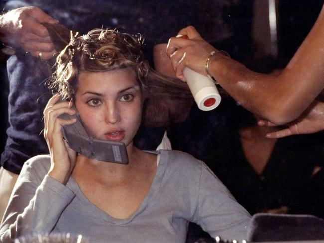 Remember what mobile phones looked like in 1997? Trump is pictured in hair and makeup backstage at a Jill Stuart fashion show in NYC. Picture: Richard Corkery/NY Daily News Archive via Getty Images