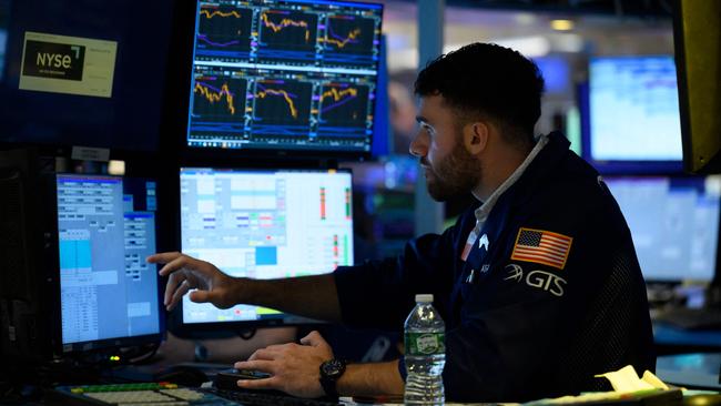 A trader works on the floor of the New York Stock Exchange (NYSE) at the opening bell on August 5, 2022 at Wall Street in New York City. - Stock markets slid Friday as a much stronger-than-expected US jobs report raised the prospect that the Federal Reserve will maintain its aggressive monetary policy to combat inflation. (Photo by ANGELA WEISS / AFP)