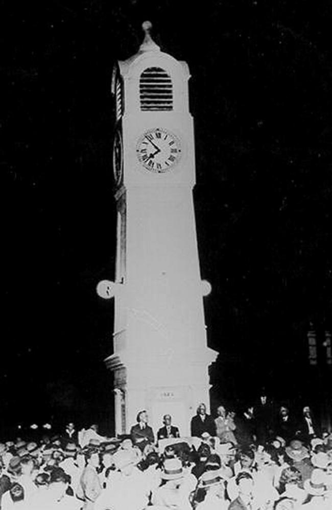 A group of people are gathered for the unveiling ceremony of the John Drysdale Memorial Clock in Queen Street, Ayr. The ceremony was held on January 15, 1930.