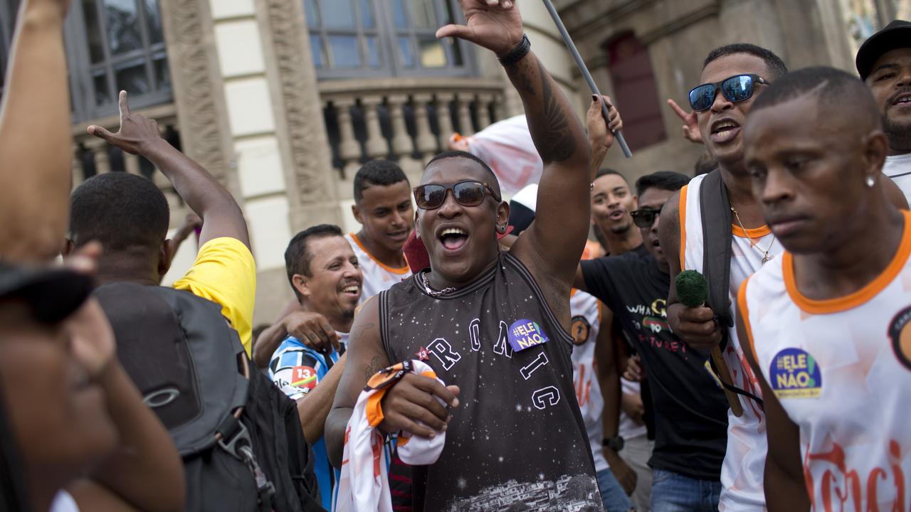 Men join in a protest against Jair Bolsonaro.