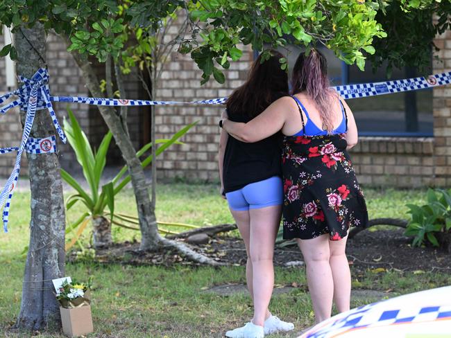 Family friends lay flowers outside the home. Picture: Lyndon Mechielsen