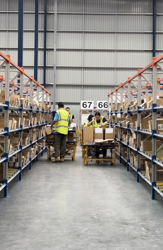 Workers at L’Oreal Groupe Queensland Distribution Centre in Redbank, Ipswich on Wednesday. Picture: Grace Koo