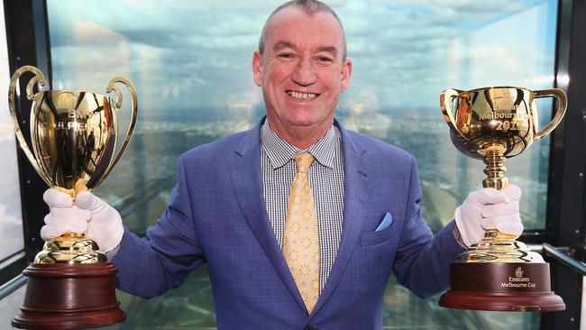 Racing Victoria’s executive general manger of racing Greg Carpenter shows off the Caulfield and Melbourne Cups on Tuesday.