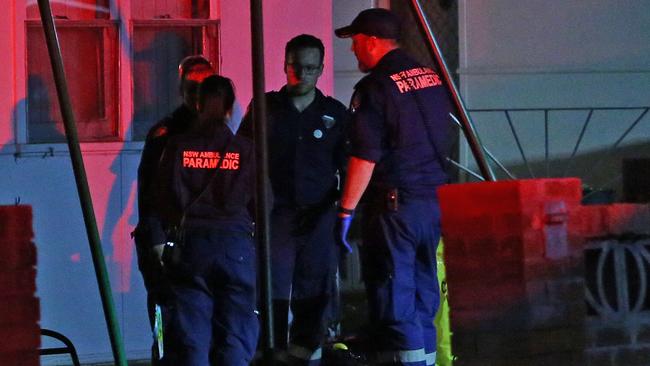 Ambulance workers pictured at the house following the man’s death. Picture: Richard Dobson