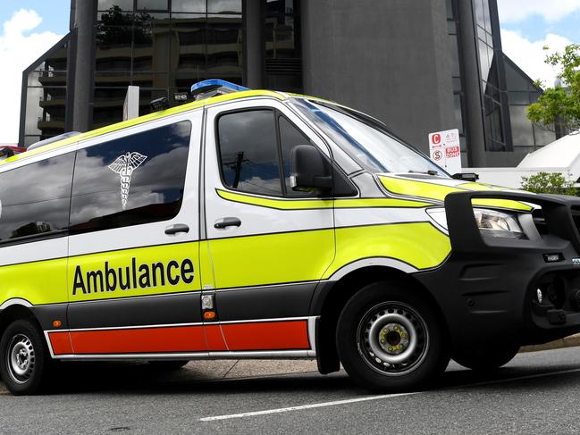 BRISBANE, AUSTRALIA - NewsWire Photos - JANUARY 13, 2021.An Ambulance leaves the Hotel Grand Chancellor in Spring Hill, Brisbane. Guests will be evacuated after six people linked to the building tested positive to the highly-contagious UK variant of the coronavirus.Picture: NCA NewsWire / Dan Peled