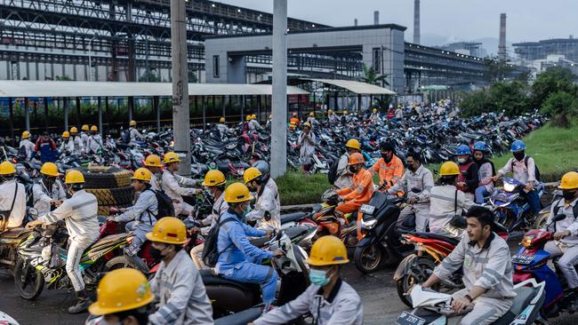 Employees in traffic during the working shift change near Indonesia Morowali Industrial Park. Picture: Garry Lotulung