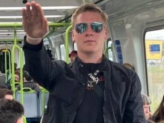 Nathan Bull, a known neo-Nazi, has been captured performing the near-banned salute onboard a busy Melbourne train. Picture: supplied