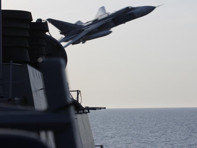 A Russian Su024 strike fighter flies fast and close to the USS Donald Cook in April this year. It was just one of a string of Cold War-style confrontations in the Baltic Sea. Picture: US Navy