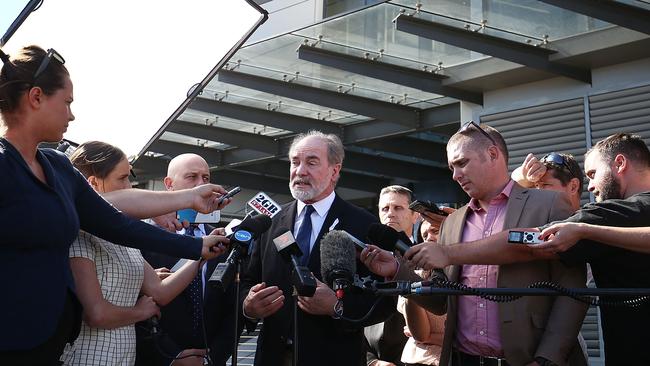 John Grant address the media outside League Central.