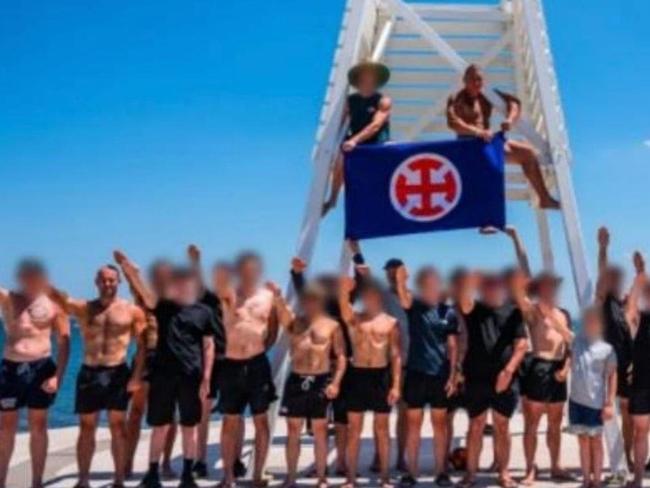 Men pose with a Australian European Movement flag and make Nazi salutes in the Melbourne suburb of Elwood in 2023. Picture: Supplied