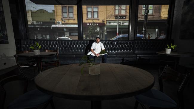 Pickett sits on a bench in his restaurant. Picture: Daniel Pockett