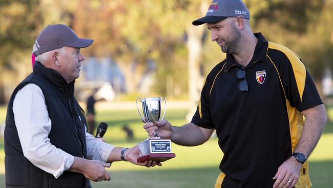 Grant Stevens presents the trophy to winning Goodwood Saints Coach Ben Johnston. Picture: Brett Hartwig