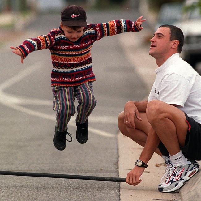 Dmitri and a young Oleg, jumping over a bar in 1999.