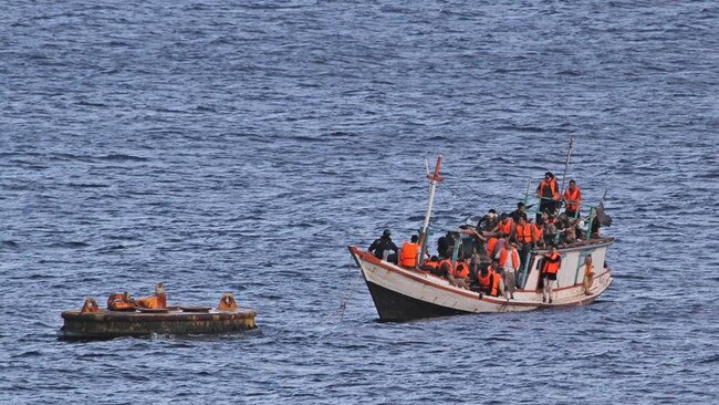 Asylum-seekers arrive to be processed at dentention centre on Christmas Island after being intercepted off northwest coast of Australia.