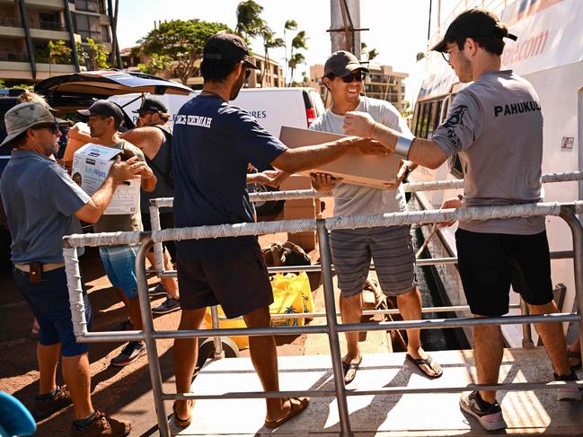 Pacific Whale Foundation volunteers load boats with supplies to deliver to West Maui before leaving Maalaea Harbor in Maalaea, Hawaii. Picture: AFP