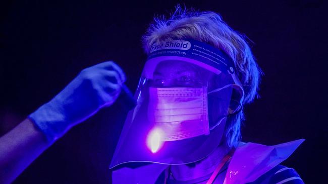 Ultra-violet light shows Manchester trainees the dangers of contamination during vaccination. Picture: Getty Images