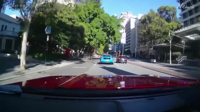 Driver clashes with cyclist after they run multiple red lights