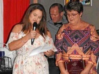 Gabe Watkin receiving her life membership to the Yeppoon Swans from close friend Rachel Boyd. Picture: Shayla Bulloch