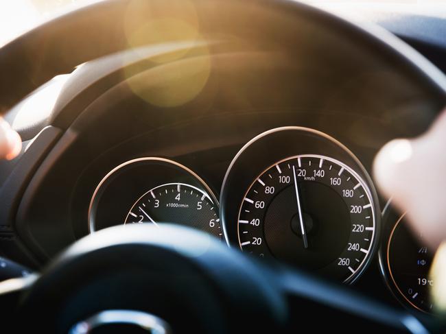 Speedometer of a car close-up, with the arrow frozen at a speed of 120 km/h. Details and interior of a black luxury car.