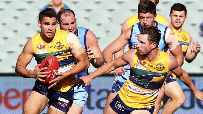 Former Crow Jared Petrenko shows his trademark attacking burst. He will miss a chunk of the SANFL season as he appears on Channel Seven home renovation program House Rules. Picture: Sarah Reed