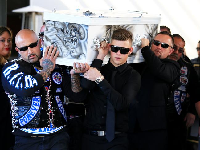 Simon's son Alex, front right, carries the casket out of the church.