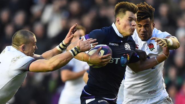 Scotland centre Huw Jones breaks the England defence to score his side’s third try in a stirring performance at Murrayfield. Picture: AFP