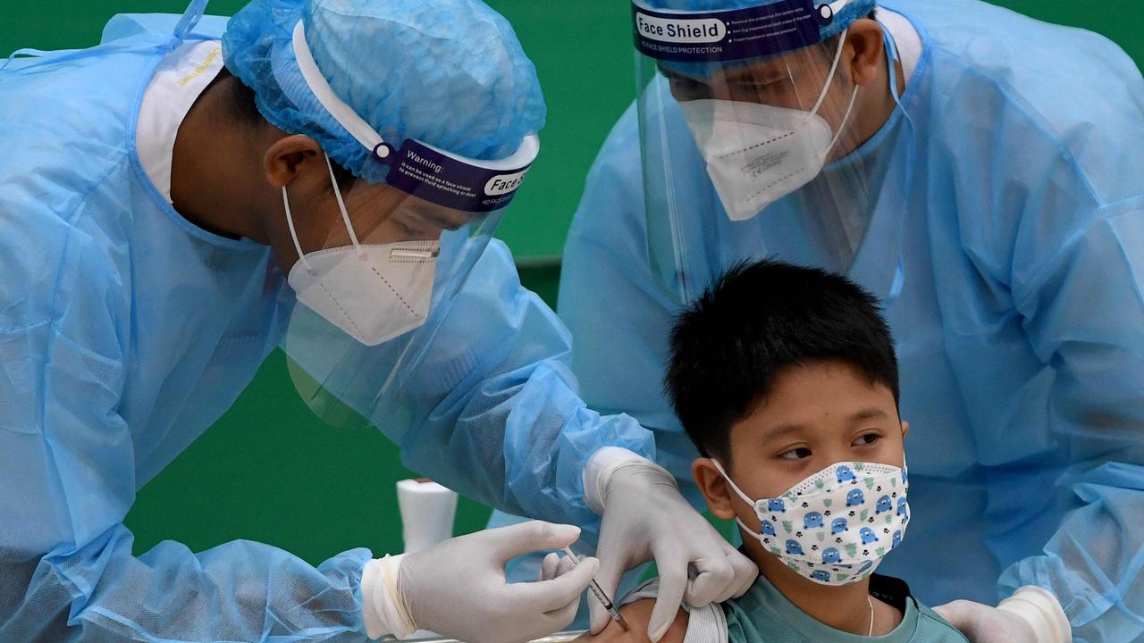 The grandson of Cambodia's Prime Minister Hun Sen receives a dose of the Sinovac Covid-19 coronavirus vaccine at the Peace Palace in Phnom Penh as the country begins vaccinating children aged between six and 12.