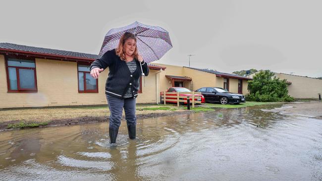 Denise Palmer of Semaphore Park in her flooded front yard. Picture: Russell Millard