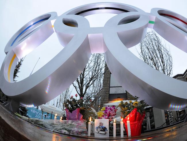 Candles and floral tributes for Georgian luge athlete Nodar Kumaritashvili are placed under the Olympic rings in Whistler, British Columbia, 12/02/2010 after Kumaritashvili died at a hospital earlier in day after a horror crash during a luge high-speed training run at resort ahead of 2010 Vancouver Winter Olympic Games.