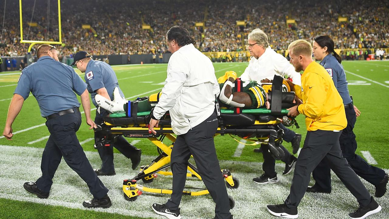 Jamaal Williams #30 of the Green Bay Packers is taken out on a stretcher after helmet-to-helmet hit.