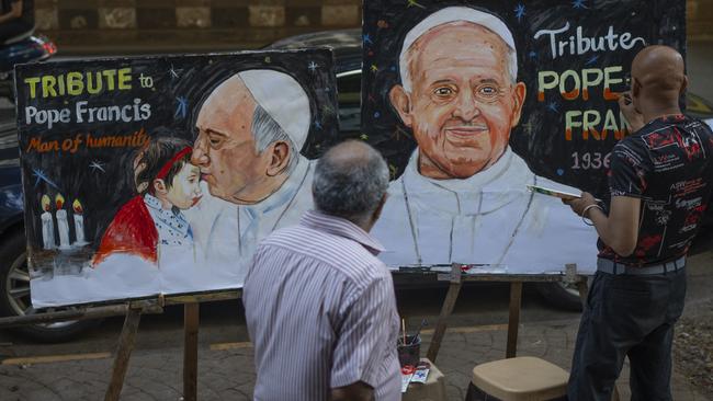 An Indian artist Sagar Kambli makes a painting of Pope Francis as a mark of tribute on a sidewalk in Mumbai, India. Picture: AP