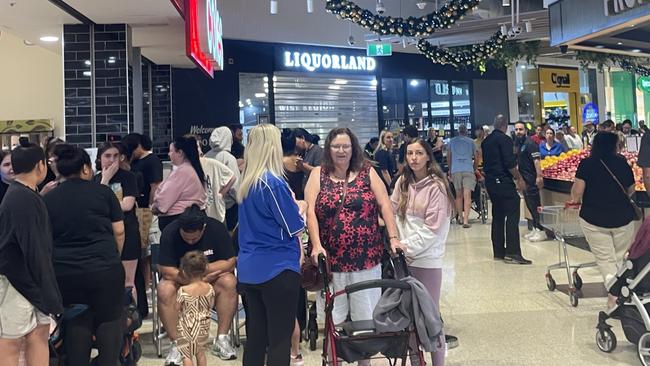 Shoppers queue at Nepean Village in Penrith on Tuesday after billionaire businessman Adrian Portelli announced he was putting down a $150,000 tab at two Sydney Coles supermarkets.