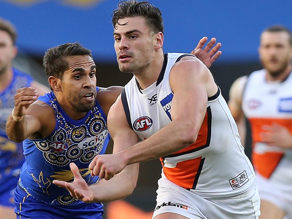 PERTH, AUSTRALIA - JULY 08: Stephen Coniglio of the Giants gets his handball away under pressure by Lewis Jetta of the Eagles during the round 16 AFL match between the West Coast Eagles and the Greater Western Sydney Giants at Optus Stadium on July 8, 2018 in Perth, Australia.  (Photo by Paul Kane/Getty Images)