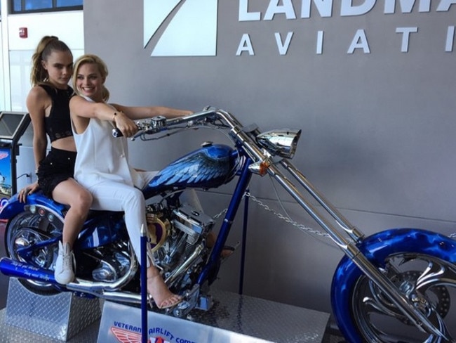 Margot Robbie and Cara Delevingne play it up on a motorbike at San Diego Comic-Con.  Picture:  Supplied