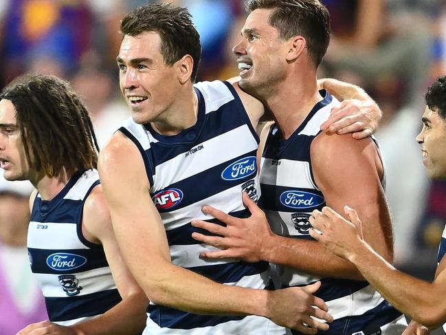 GEELONG, AUSTRALIA - APRIL 08: Tom Hawkins of the Cats is congratulated by team mates after kicking a goal during the round four AFL match between the Geelong Cats and the Brisbane Lions at GMHBA Stadium on April 08, 2022 in Geelong, Australia. (Photo by Quinn Rooney/Getty Images)