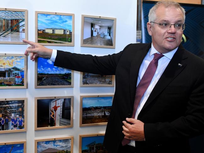 BRISBANE, AUSTRALIA - NewsWire Photos - MAY 18, 2021. Australian Prime Minister Scott Morrison points at pictures of newly built houses, purchased by employees of Taipan Hose Systems in Caboolture, north of Brisbane. The houses were purchased with the help of the home builder grant.Picture: NCA NewsWire / Dan Peled