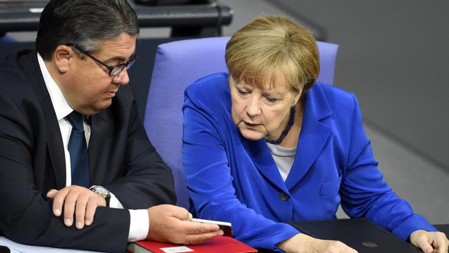 German Chancellor Angela Merkel, right, during a session of the German Bundestag.