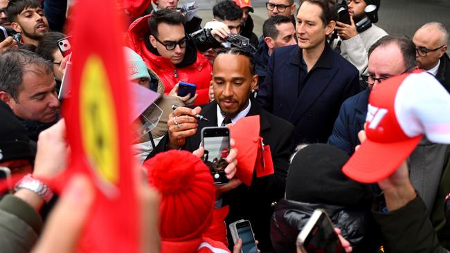 FIORANO MODENESE, ITALY - JANUARY 20: Sir Lewis Hamilton greets fans during his first official days as a Scuderia Ferrari F1 driver at Fiorano Circuit as John Elkann, CEO of Exor, looks on, on January 20, 2025 in Fiorano Modenese, Italy.  (Photo by Rudy Carezzevoli/Getty Images) *** BESTPIX ***