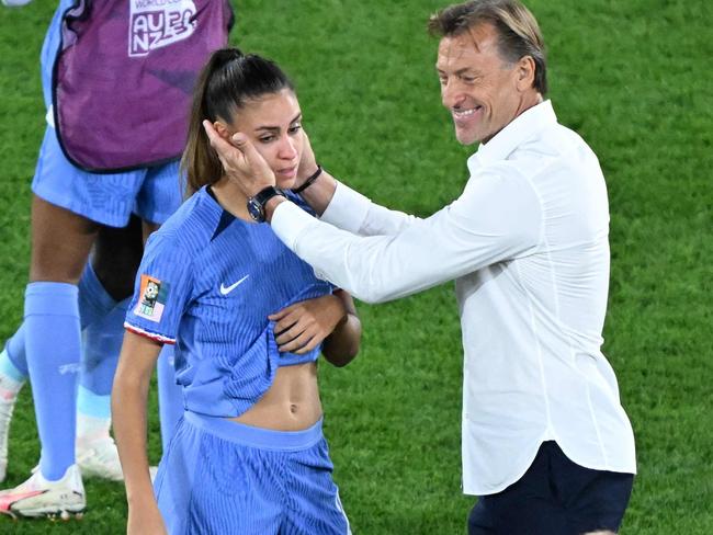 France's coach Herve Renard comforts a player after defeat during the Australia and New Zealand 2023 Women's World Cup quarter-final football match between Australia and France at Brisbane Stadium in Brisbane on August 12, 2023. (Photo by WILLIAM WEST / AFP)