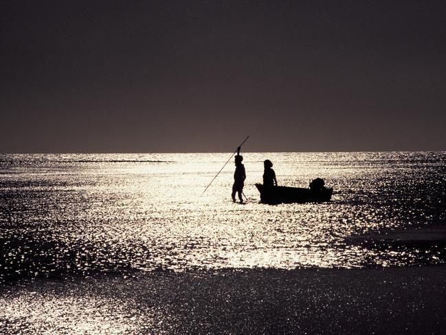 A Portrait of Australia: The best stories from 30 years of Australian Geographic. In a shimmering sea, Gula Lalara stalks fish as countless generations have done before him. Behind him, his wife Geraldine pulls their outboard runabout, a symbol of the new world that is drawing the Eylandters away from their timeless existence. Photo by Edward Stokes.