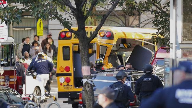 Authorities respond near a damaged school bus at scene. Picture: AP