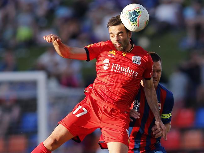 Adelaide’s Nikola Muleusnic heads the ball. Picture: AAP