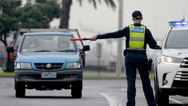 Police check drivers at a random checkpoint in Port Melbourne. Picture: Andrew Henshaw