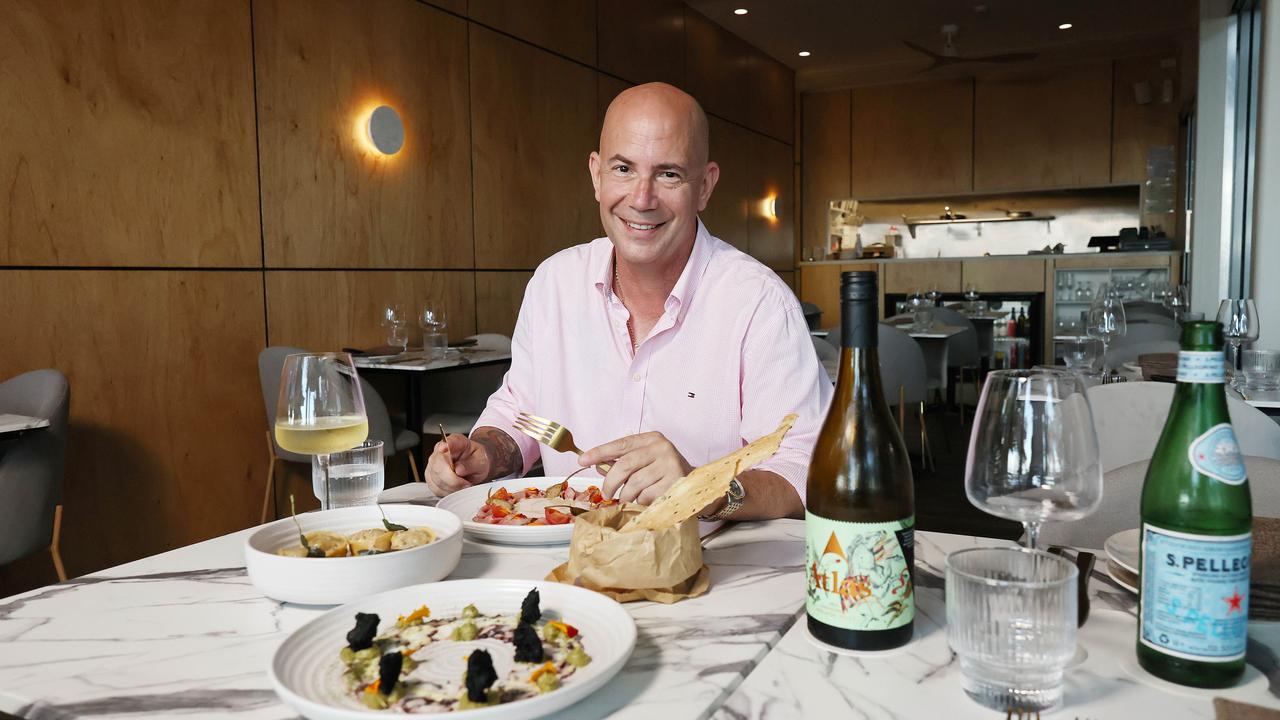 A new restaurant and adjoining bar have opened in the Drift apartment building at Palm Cove, opposite Miguel's tapas restaurant. Ignis restaurant owner Michael Kohn with the vitello tonnato, the hand made butter sage pasta and the octopus carpaccio. Picture: Brendan Radke
