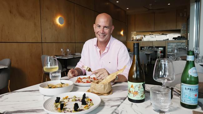 A new restaurant and adjoining bar have opened in the Drift apartment building at Palm Cove, opposite Miguel's tapas restaurant. Ignis restaurant owner Michael Kohn with the vitello tonnato, the hand made butter sage pasta and the octopus carpaccio. Picture: Brendan Radke