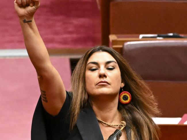 ONE TIME WEB USE FOR NEWS.COM.AU - FEES APPLY -  Australia Greens Senator for Victoria Lidia Thorpe raises her arm during her swearing-in ceremony in the Senate chamber at Parliament House in Canberra, Monday, August 1, 2022. (AAP Image/Lukas Coch) NO ARCHIVING