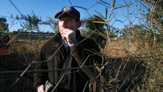 Mr Abbott samples some of the local produce from the Bushtucker Project in Amata in the Anangu Pitjantjatjara Yankunytjatjara Lands. Picture: Lindsay Moller