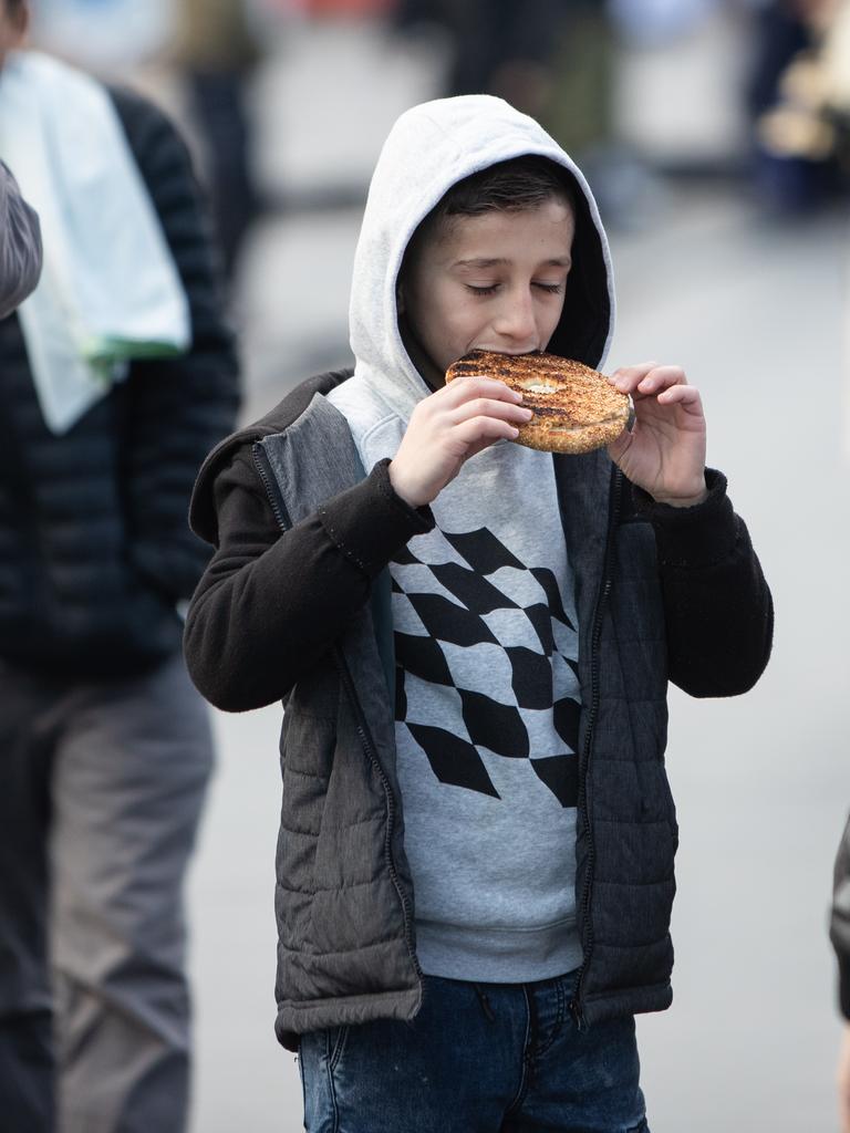 A boy enjoys a snack outside Lakemba Mosque after Eid prayers. Picture: Julian Andrews. Photos can be purchased at newsphotos.com.au