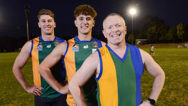 Golden Grove Football Club players Connor Hillcoat (left) and Tom Tacono (centre) in heritage guernseys with inaugural player Phil Jordan (right) in an original guernsey. The club is celebrating its 25th year and this weekend will be wearing throwback jumpers this Saturday to what the first senior teams wore in the 90s. Picture: Brenton Edwards