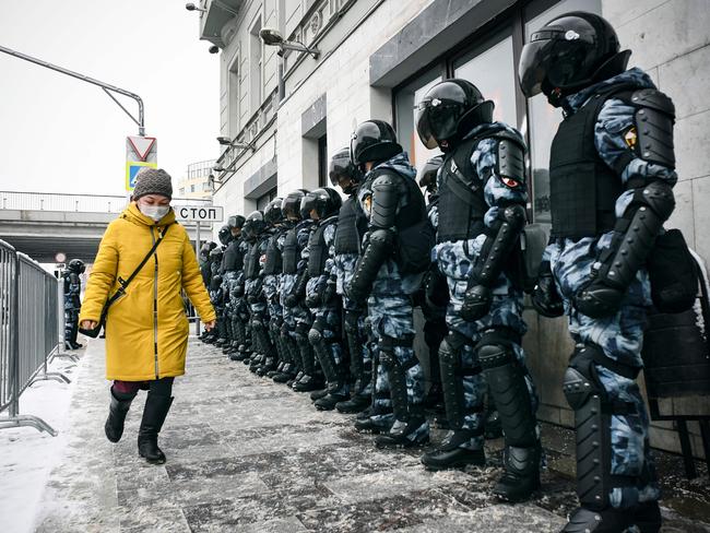 A woman walks in front of riot police during a rally in support of jailed opposition leader Alexei Navalny in Moscow. Picture: AFP